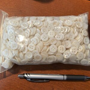 Woman in white dress walking through blooming cherry trees