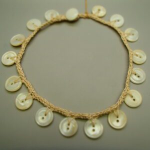 Golden retriever puppy lying in green grass outdoors