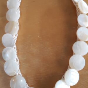 Person hiking on snowy mountain trail with scenic valley view