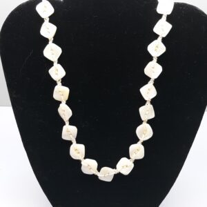 Golden retriever dog sitting on wooden deck outdoors