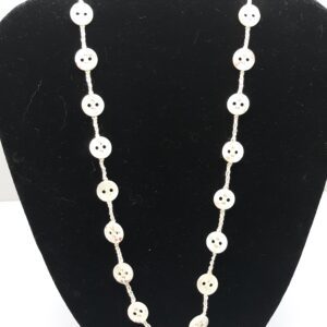 Woman in white dress standing in golden wheat field