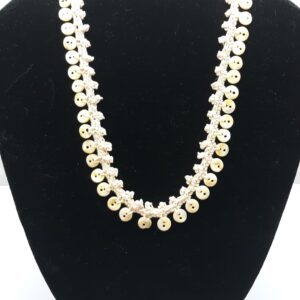 Woman in hijab smiling at camera indoors