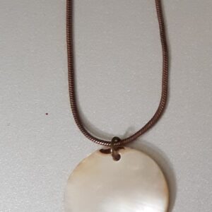 Woman in red jacket walking through snowy forest path