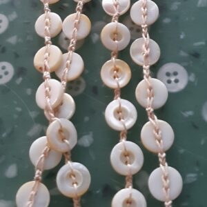 Golden retriever puppy sitting in green grass outdoors