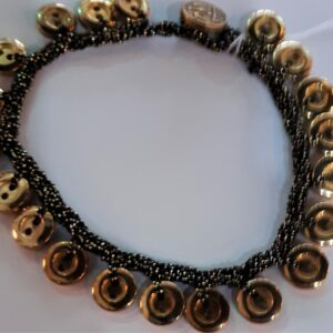 Young woman wearing white headphones using smartphone outdoors