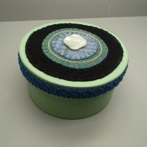 Person in cozy knit sweater holding steaming coffee mug