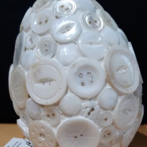 Golden retriever puppy sitting on wooden floor indoors