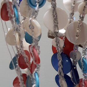 Woman in business attire holding smartphone and coffee cup