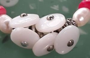 White cat sleeping peacefully on gray couch