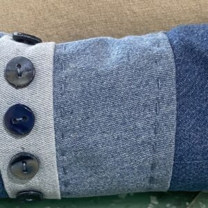 Person in blue shirt working at computer desk