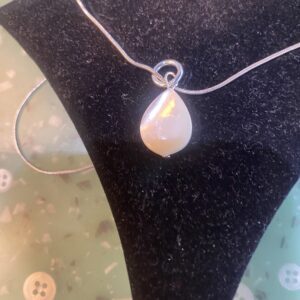 Woman in white shirt reading book indoors