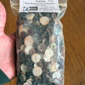 Modern apartment building with glass balconies and green landscaping